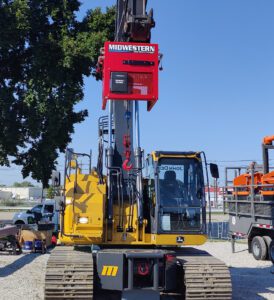 Midwestern M08W hydraulic winch attachment mounted on a John Deere excavator with hook and wire rope