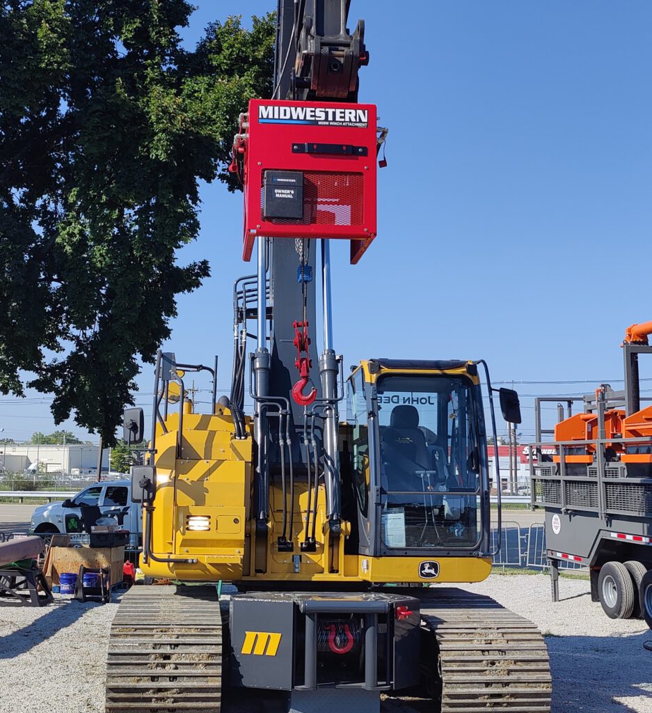 Midwestern M08W hydraulic winch attachment mounted on a John Deere excavator with hook and wire rope